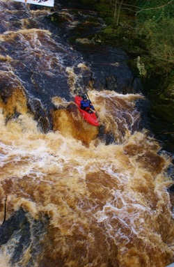 Kayaer david Horkan paddling over waterfall